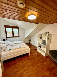 a bedroom with a bed and a wooden ceiling at Charmante Ferienwohnung Ziegler mit Garten in Villmar +22 photos