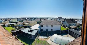an aerial view of a town with a white house at Charmante Ferienwohnung Ziegler mit Garten in Villmar