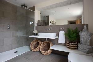 a bathroom with a sink and a shower and a toilet at Willowbrook House- A luxurious countryside retreat set in an idyllic & desirable location close to Soho Farmhouse and lots of Cotswold attractions - Dogs welcome in Kiddington +58 photos