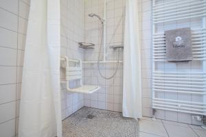 a bathroom with a shower and a sink at Feriendorf Südstrand Haus 18 in Pelzerhaken