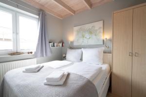 a bedroom with a bed with two towels on it at Feriendorf Südstrand Haus 18 in Pelzerhaken