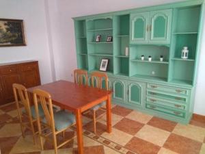 a dining room with a wooden table and chairs at Piso Calle Pelayo in Villanueva de Córdoba