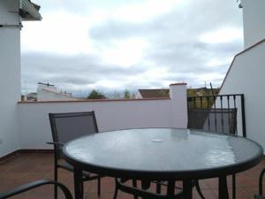 a table and chairs sitting on a balcony at Piso Calle Pelayo in Villanueva de Córdoba