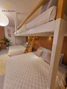a bedroom with two bunk beds and a ladder at El Nissi Staycation, THE BARIQUIT SUITE, Enchanted Kingdom in Santa Rosa