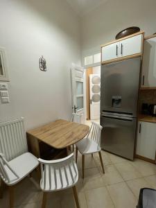 a kitchen with a wooden table and a refrigerator at Varvayanni Villa in Plomari