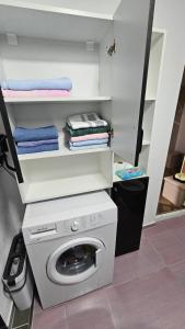 a washer and dryer in a laundry room with at CoraHome Ultra Central in Corabia