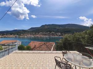 a patio with a view of the water and mountains at Sunflower House in Vathi, Ithaka