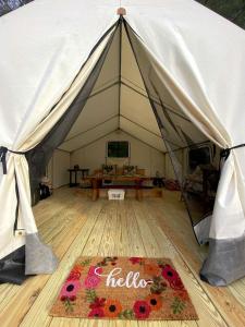 a tent with a rug on a wooden floor at Gorgeous Safari Tent Rental Ideal for Glamping in Upstate New York in Wevertown +11 photos