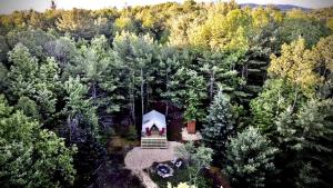 an aerial view of a tent in the middle of a forest at Gorgeous Safari Tent Rental Ideal for Glamping in Upstate New York in Wevertown