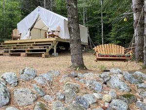 a tent and two chairs in front of some rocks at Gorgeous Safari Tent Rental Ideal for Glamping in Upstate New York in Wevertown