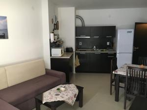 a living room with a couch and a kitchen at Atlantis Getaway in Burgas City