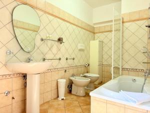 a bathroom with a sink and a tub and a toilet at Marinaway - Appartamenti a 2 chilometri dal mare in Orosei +57 photos