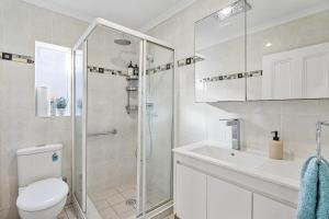 a bathroom with a shower and a toilet and a sink at Huge, Inner Sydney City 5 Bed Mansion, Near Opera House - 7 mins in Sydney +17 photos