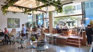 a group of people sitting at tables in a restaurant at Huge, Inner Sydney City 5 Bed Mansion, Near Opera House - 7 mins in Sydney