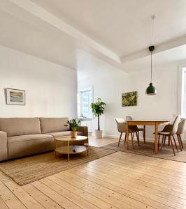 a living room with a couch and a table at Andra in Aalborg