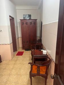 a bathroom with a table and chairs and a cabinet at Tân Ty Mon Hotel in Ho Chi Minh City