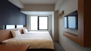 Postel nebo postele na pokoji v ubytování Hotel Glad One Kyoto Shichijo by M's