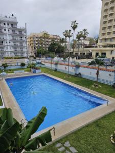 a large swimming pool in a city with buildings at Near the beach bus Playa Jardín in Puerto de la Cruz