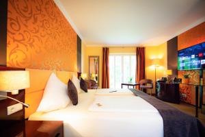 Vuode tai vuoteita majoituspaikassa Hotel Sonnenhof