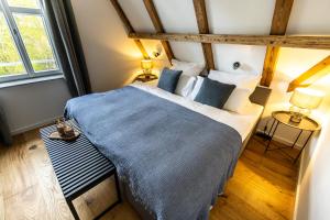 a bedroom with a bed with a blue blanket at Traumzeit Apartments in Dinkelsbühl