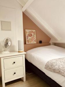 a bedroom with a bed and a nightstand with a fan at MiCASA, Studio avec Clim hyper centre in Tours