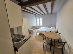a kitchen and dining room with a table and a stove at La Vie Seaside Residences in Šibenik