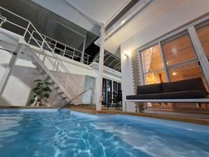 a house with a swimming pool and a staircase at Superb 3 Bed Pool Villa in Ban Saiyuan (1)