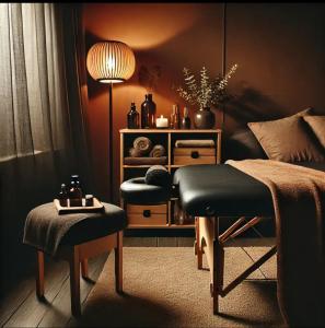 a bedroom with a bed with a ottoman and a table at Golden House in Waterbeach