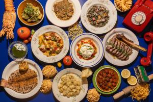 a table with many plates of food on it at Beach Walk Boutique Jumeirah in Dubai