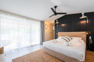 Ένα ή περισσότερα κρεβάτια σε δωμάτιο στο Doudou Hôtel