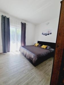 a bedroom with a bed and a large window at Apartmani Marina Vir centar in Vir