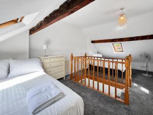a bedroom with a bed and a crib at 3 Bed House Sleeps 8 Garden & Driveway - Central Location - Amaya 10 - Free Gym Access in Lincolnshire