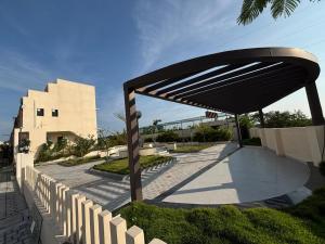 a pavilion in front of a building with a fence at New Moon Resort in Chennai