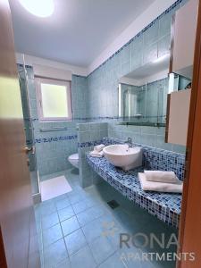 a bathroom with a sink and a toilet at Rona Spacious apartment with a panoramic view in Ičići