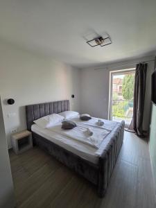 a large bed in a bedroom with a large window at H&H Rooms Rovinj - Adults Only in Rovinj