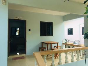 a room with a staircase and a table and chairs at Seasalt house 3 in Ban Madua Wan