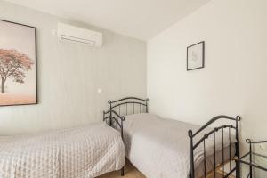 Posteľ alebo postele v izbe v ubytovaní Villa Palanga