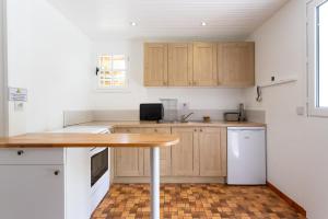 a kitchen with wooden cabinets and a wooden table at Chalet de Gretteguerre in Lanne en Barétous