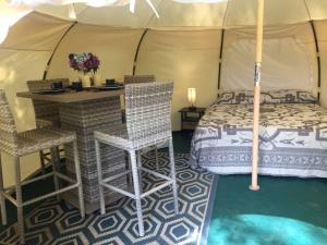 a bedroom with a bed and a table in a tent at Glamping Getaway on an Impressive Farm near Charlottesville, Virginia in Gordonsville