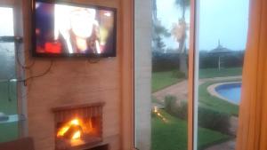 TV a/nebo společenská místnost v ubytování Appartement au Bord de la Mer