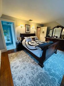 a bedroom with a large bed and a mirror at Luxury Estate Elegant Private The White Lion Manor in Middletown