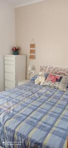 a teddy bear sitting on a bed in a bedroom at Apartamento con encanto in Torredembarra