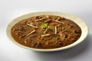 a bowl of soup with beans and cheese at Super Collection O R K International Near Gautam Buddha Park in Lucknow