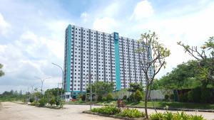 a large white building with a blue at Dancenter Bekasi Formerly Riverdale in Tanahbaru