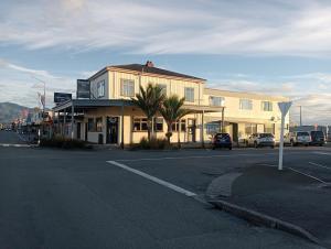 a building on the corner of a street at Cosmopolitan Hotel, pub, restaurant and gaming room in Westport