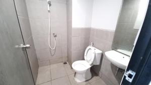 a bathroom with a shower and a toilet and a sink at Dancenter Bekasi Formerly Riverdale in Tanahbaru +26 photos