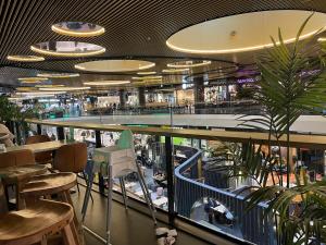 a restaurant with a bar and some tables and chairs at Fredika, modern 1br,Tripla Pasila prime location, gym, parking, train station near in Helsinki