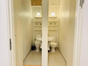 a small bathroom with a toilet and a sink at aday - 8 bedroom Apartment on the Pedestrian Street in Aalborg