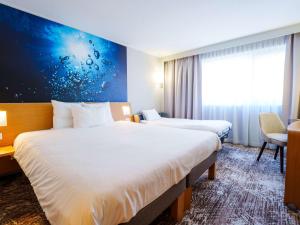 Postel nebo postele na pokoji v ubytování Novotel Saint Avold