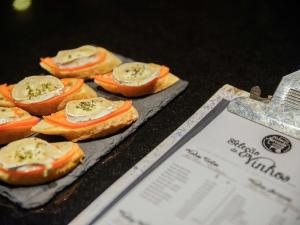 a group of small pizzas on a table at Novotel Porto Gaia in Vila Nova de Gaia